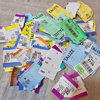 A big pile of colourful thrift store price tags